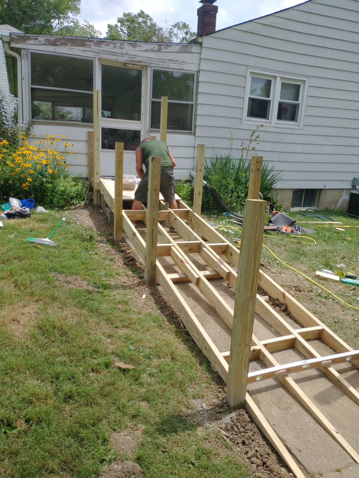 Pressure-treated deck framing built off the back of a house