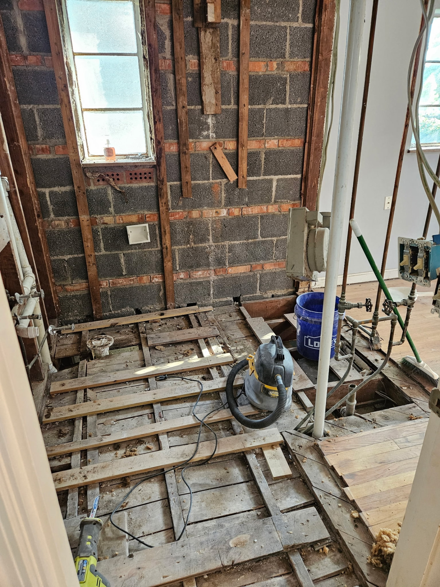 Subfloor and joists exposed during a bathroom rebuild