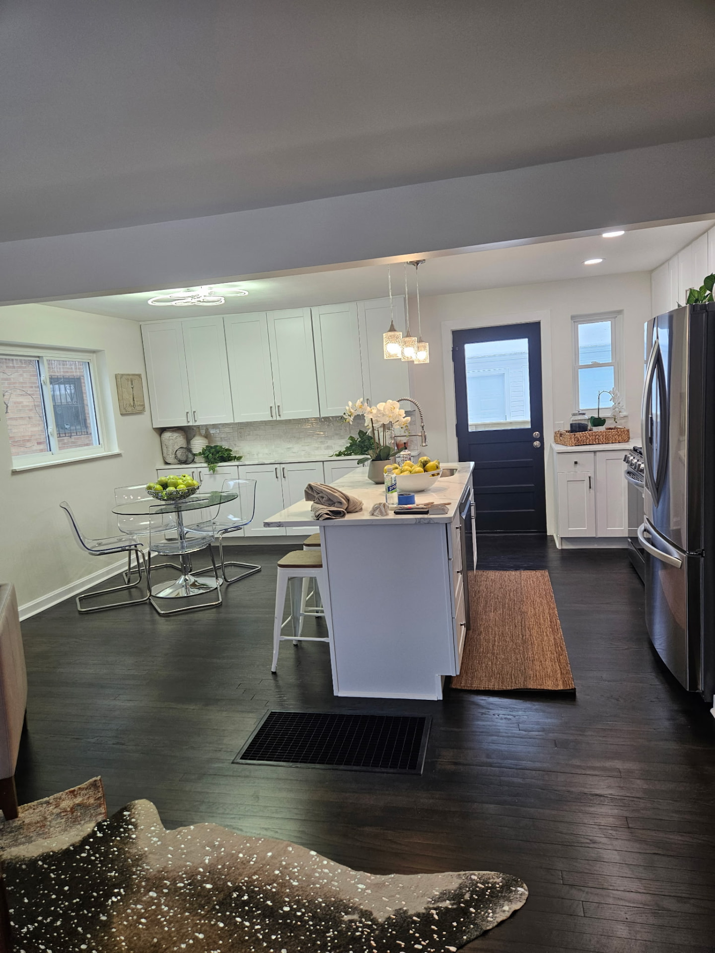 Open kitchen and dining area with new laminate flooring and cabinets